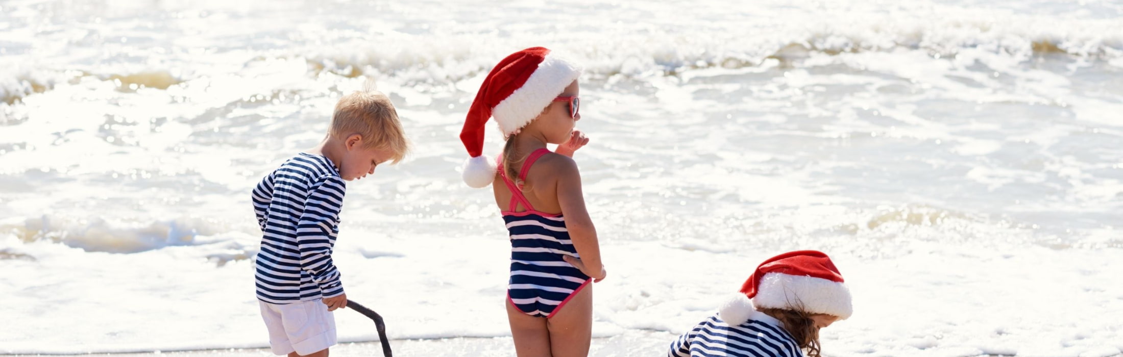 Children on beach at Christmas. Representative of parents and children facing their first christmas after separation or their christmas after divorce.