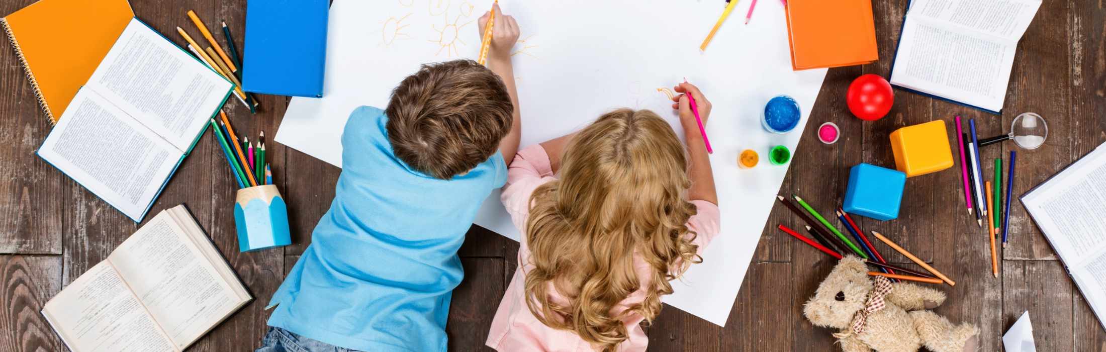 Two children drawing on the floor. Symbolic of this guide to separation and divorce resources for parents.